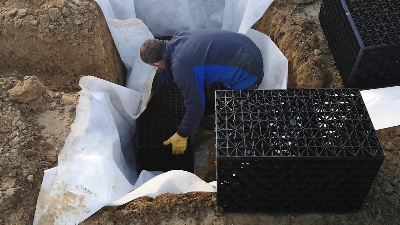 Soakaway installation in North London with excavator and operator